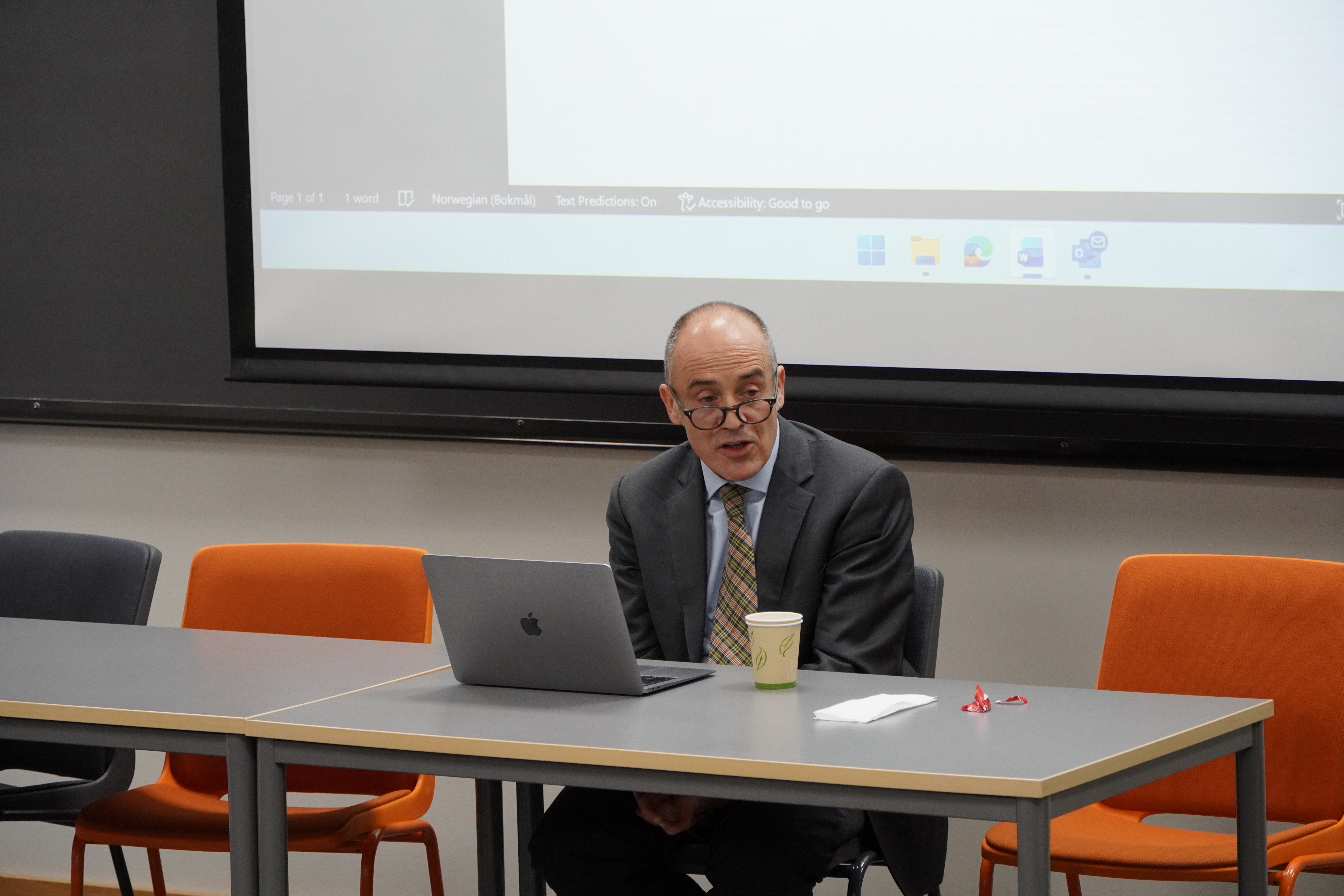 Key-note speaker Roger is talking to the audience